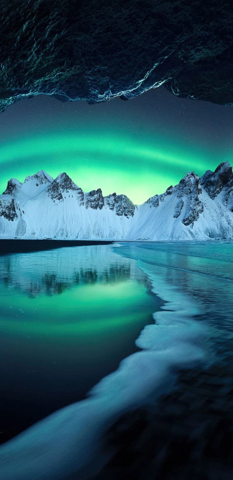 Aurora Borealis Over a Frozen Beach and Mountains 4K Mobile Wallpaper