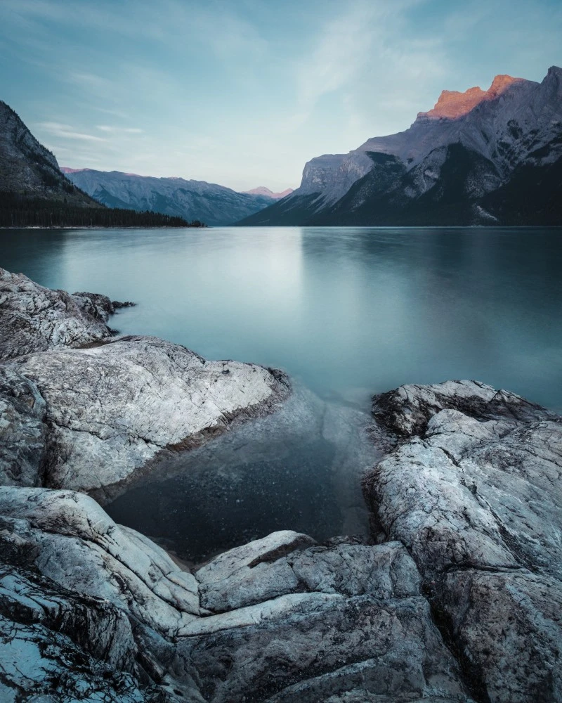 Rocky Shoreline at Sunset 4K Mobile Wallpaper