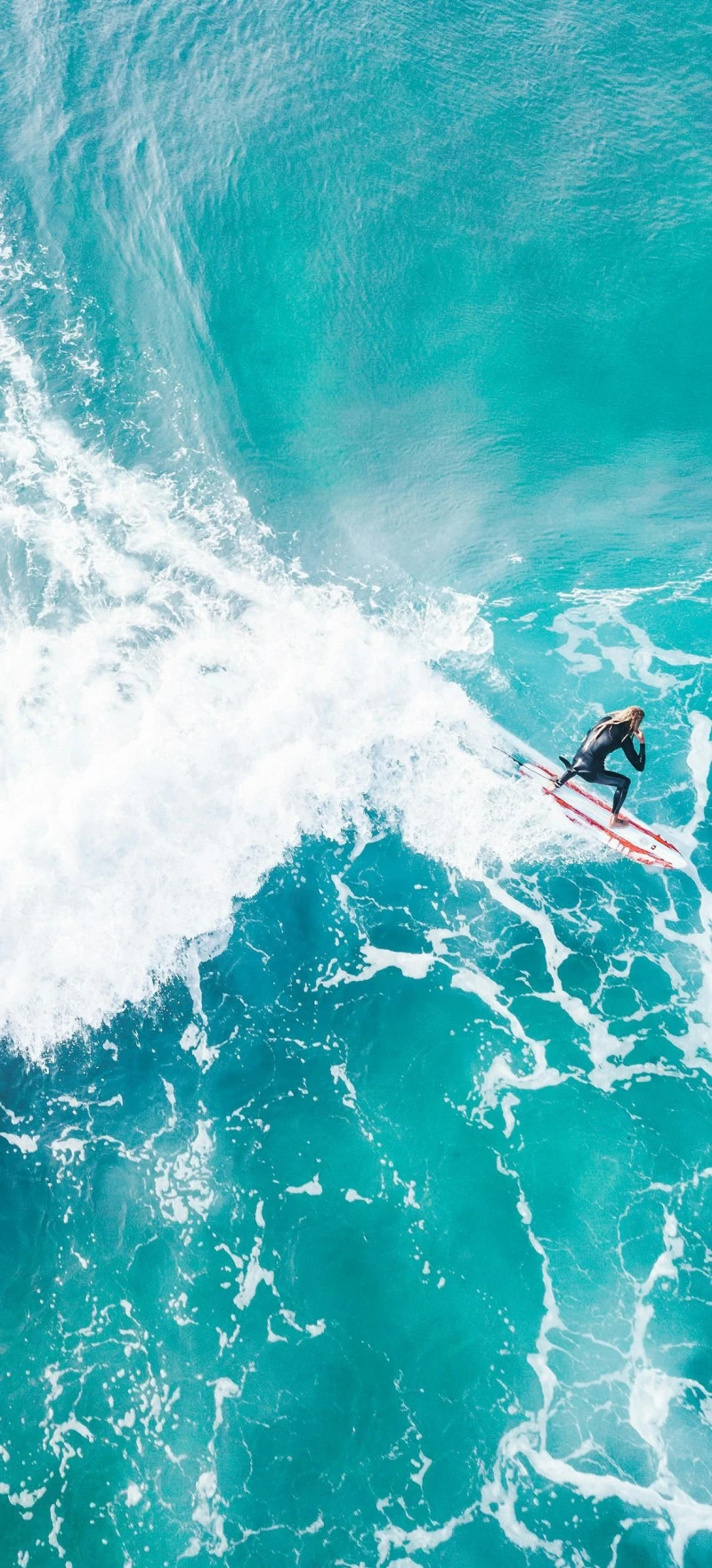 Aerial View of Surfer Riding a Wave 4K Mobile Wallpaper