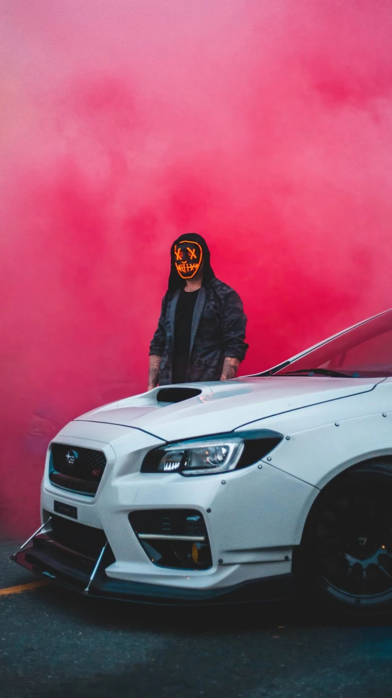 Masked Figure with Car 4K Mobile Wallpaper