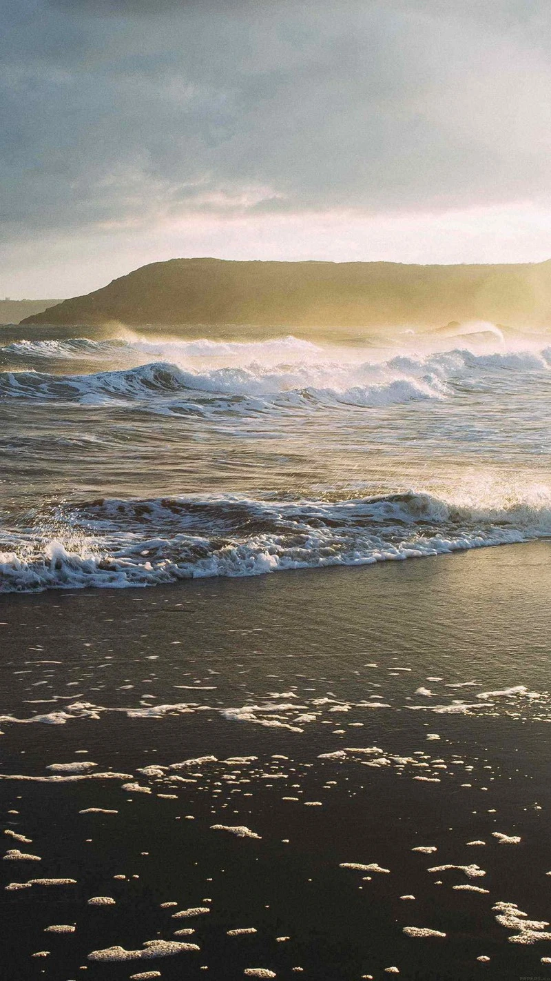 Ocean Waves Crashing on Sandy Beach at Sunset 4K Mobile Wallpaper