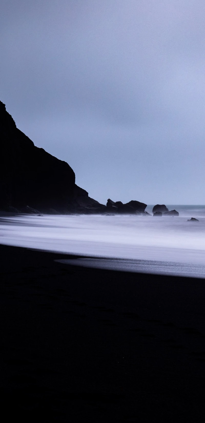 Black Sand Beach Mystery 4K Mobile Wallpaper