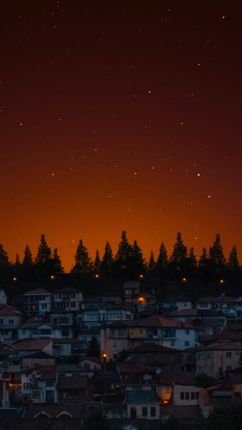 Starry Night over Hilltop Town 4K Mobile Wallpaper