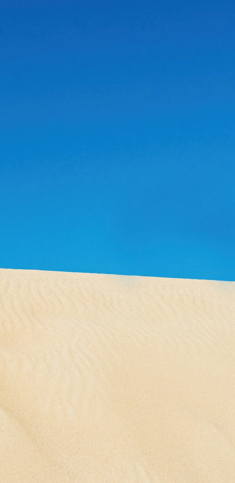 Desert Sands Under a Vibrant Blue Sky 4K Mobile Wallpaper