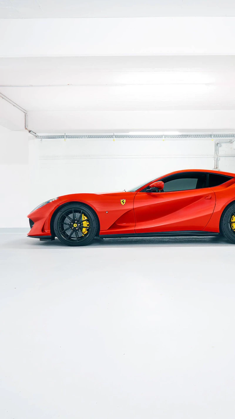 Sleek Red Ferrari in Parking Garage 4K Mobile Wallpaper