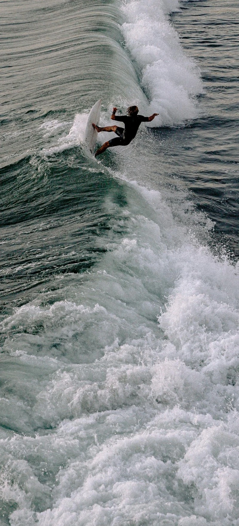 Surfer Taking on a Wave 4K Mobile Wallpaper