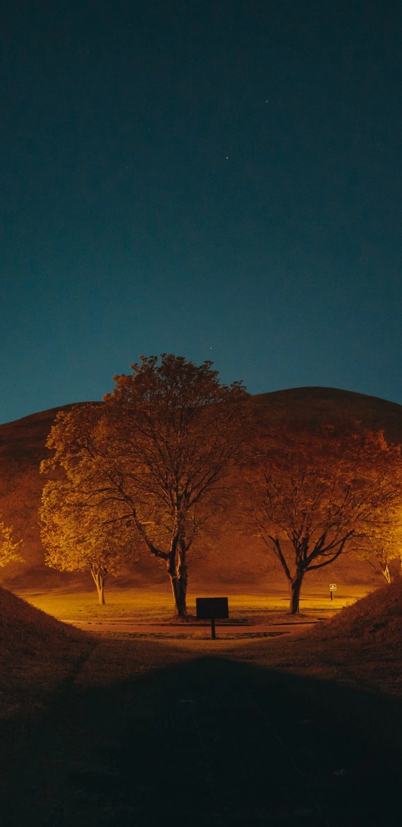 Nighttime Illumination of Ancient Mounds 4K Mobile Wallpaper