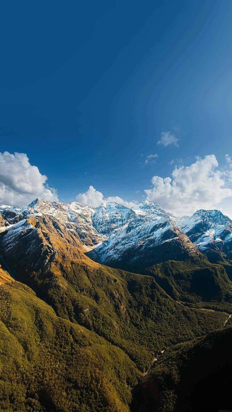 Snow-Capped Peaks Under a Clear Sky 4K Mobile Wallpaper