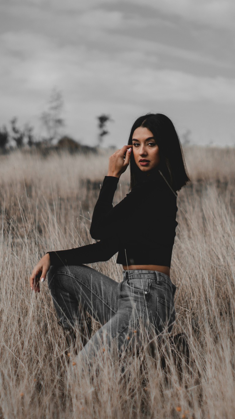 Girl in Black Top and Jeans in Field 4K Mobile Wallpaper
