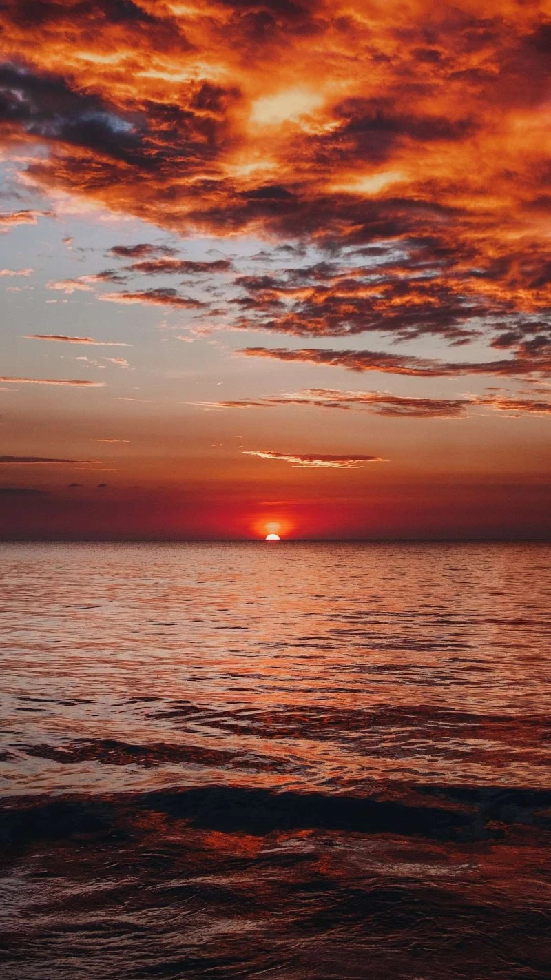 Fiery Sunset Over the Ocean 4K Mobile Wallpaper