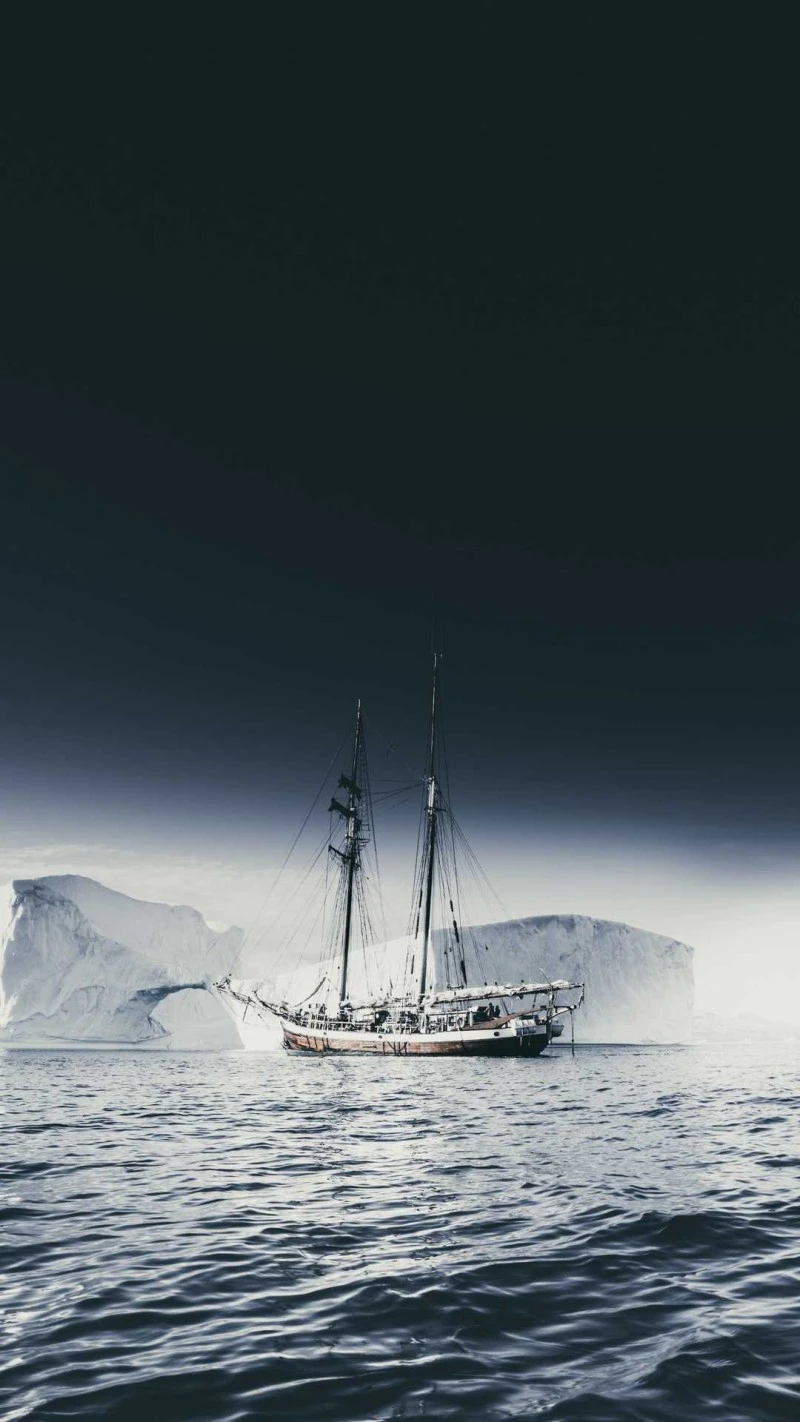 Sailboat Amidst Icebergs 4K Mobile Wallpaper