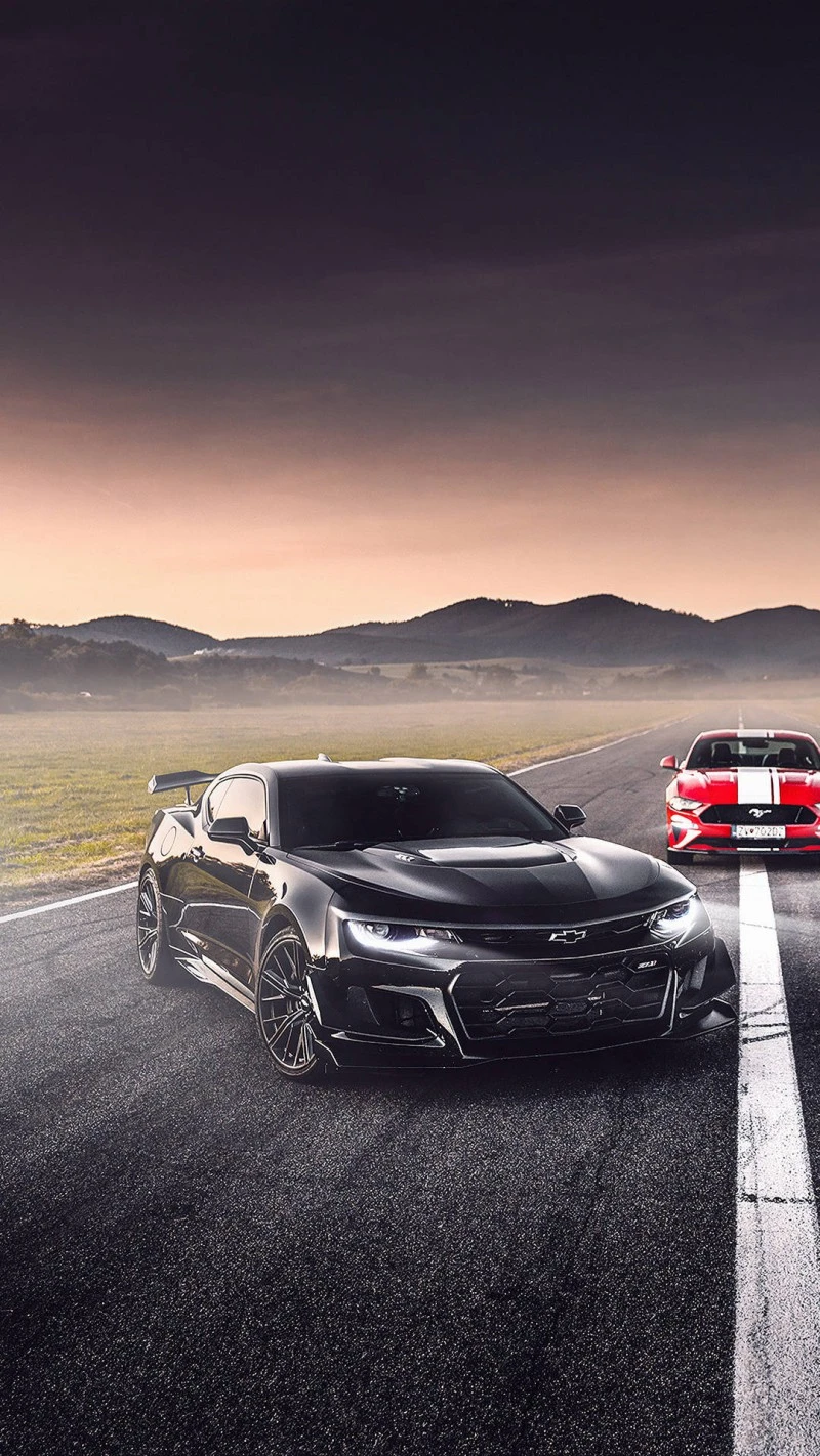 Black Camaro and Red Mustang on a Race Track 4K Mobile Wallpaper