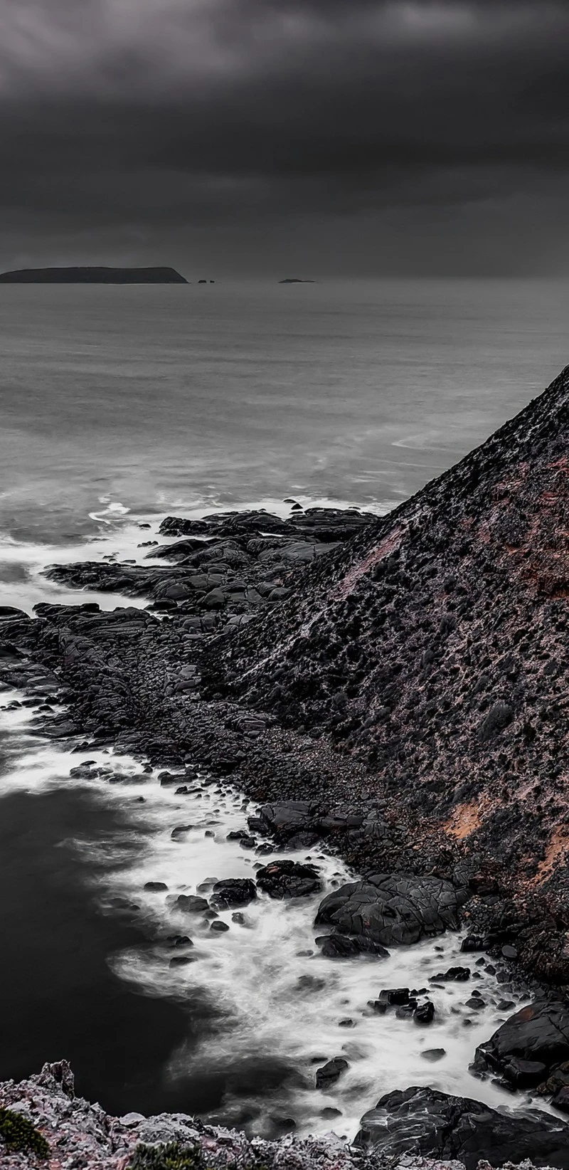 Dramatic Coastal Scene with Dark Rocks and Waves 4K Mobile Wallpaper