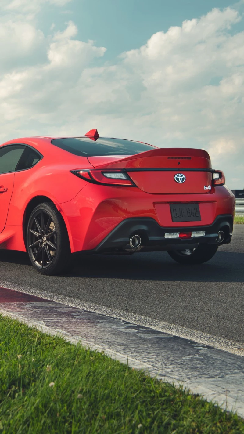 Rear View of a Red Toyota GR86 on a Racetrack 4K Mobile Wallpaper