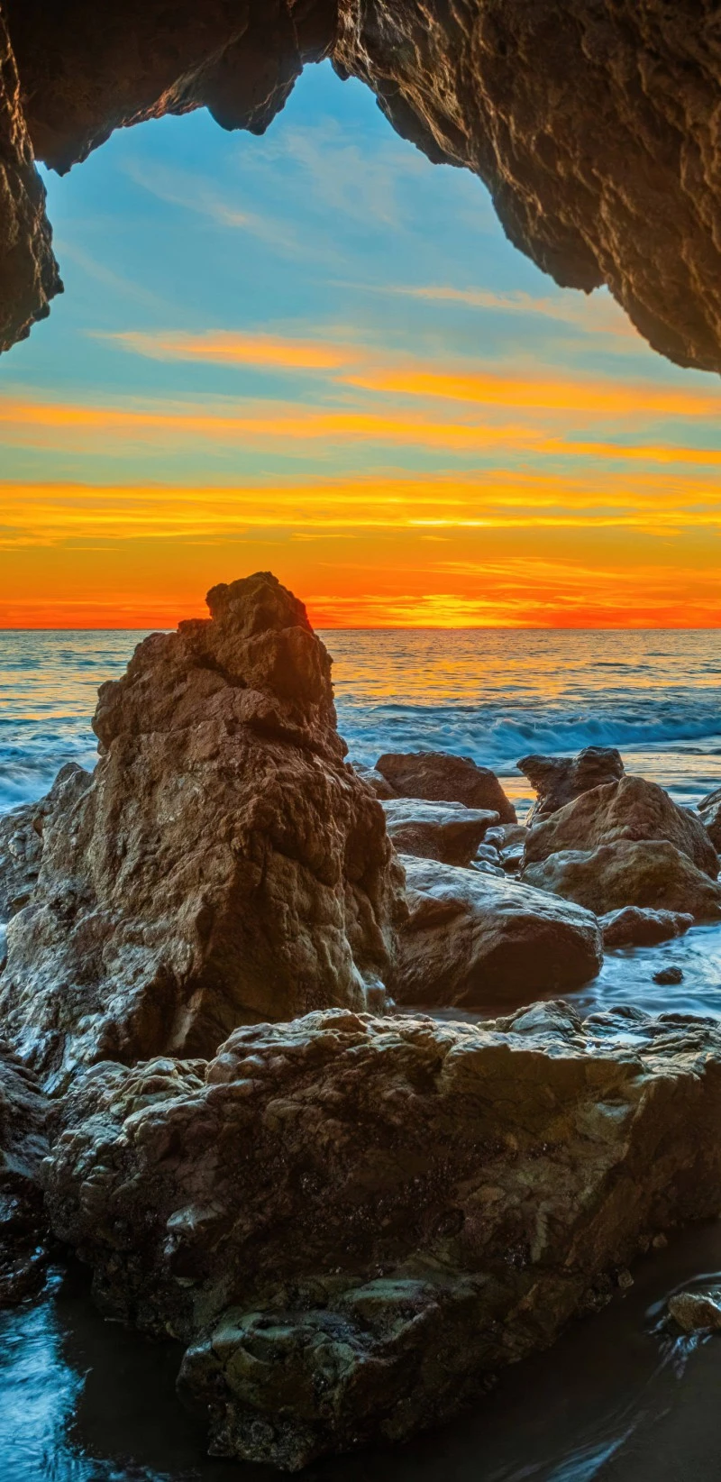 Sunset through a Coastal Cave 4K Mobile Wallpaper