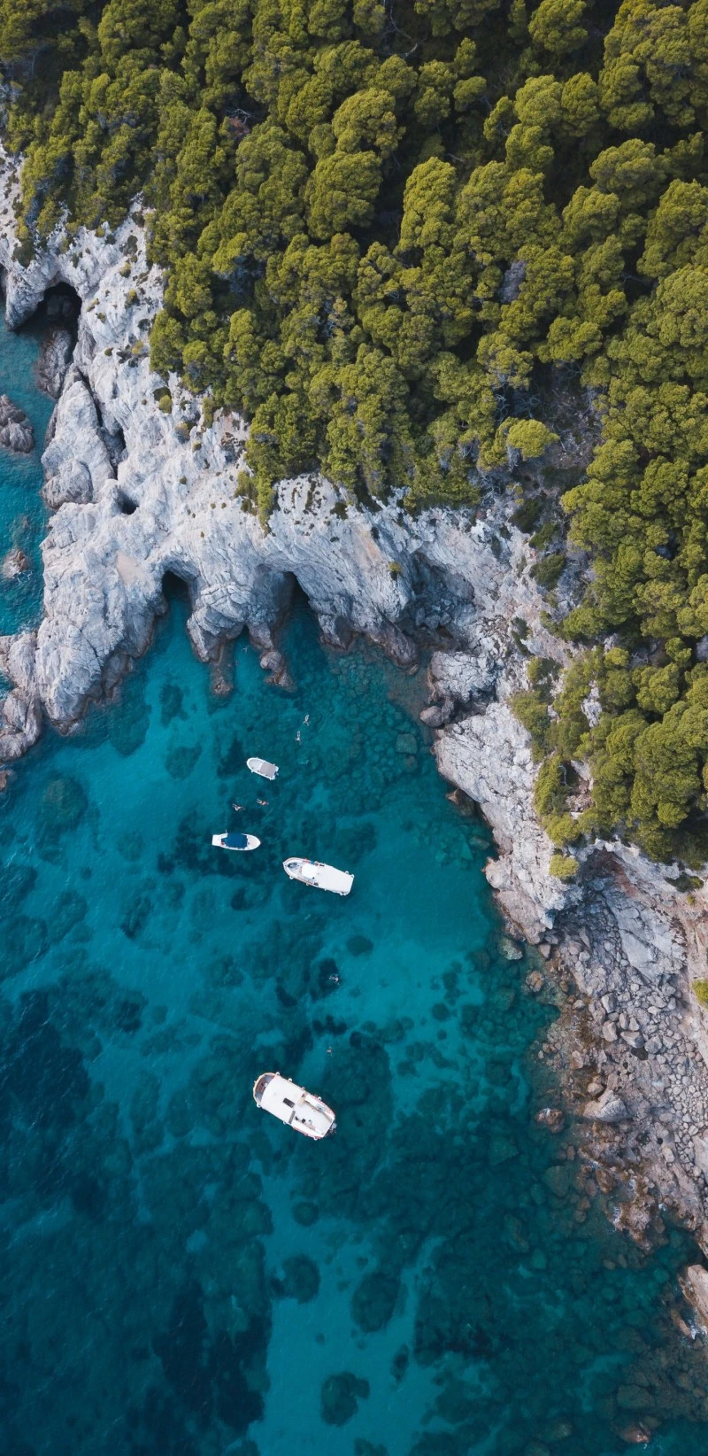 Secluded Coastal Cove with Boats 4K Mobile Wallpaper
