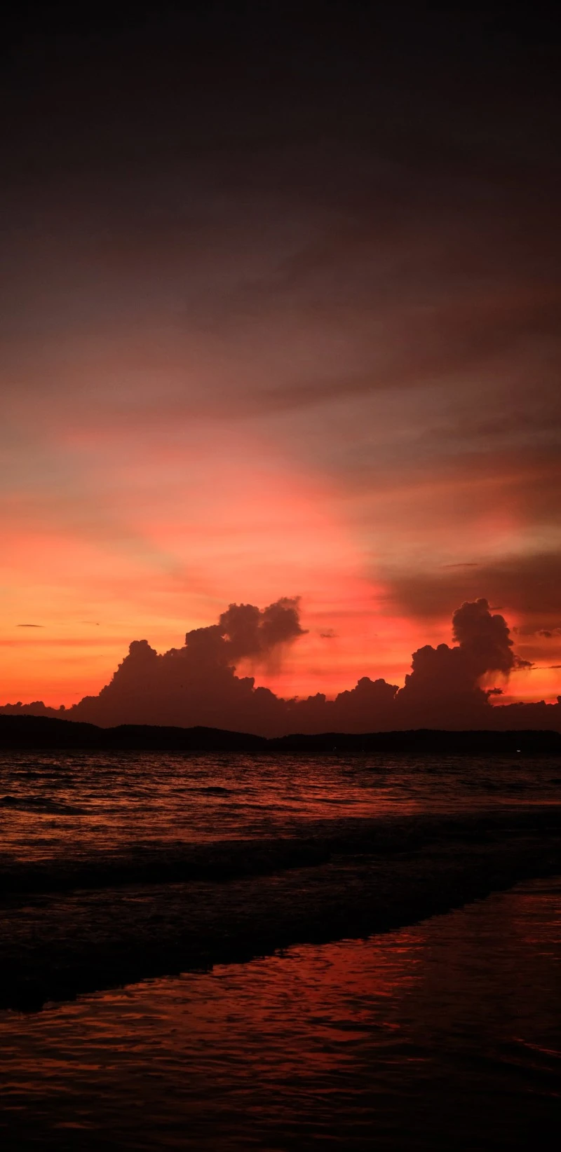 Silhouetted Sunset over Calm Ocean 4K Mobile Wallpaper