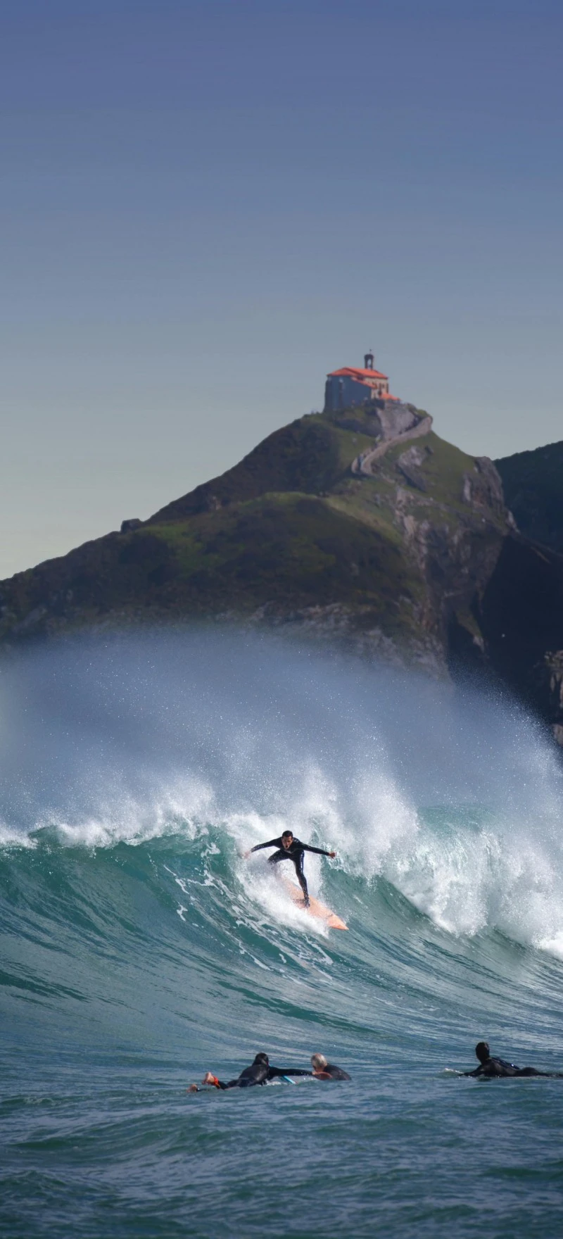 Surfer Riding a Wave with Scenic Background 4K Mobile Wallpaper
