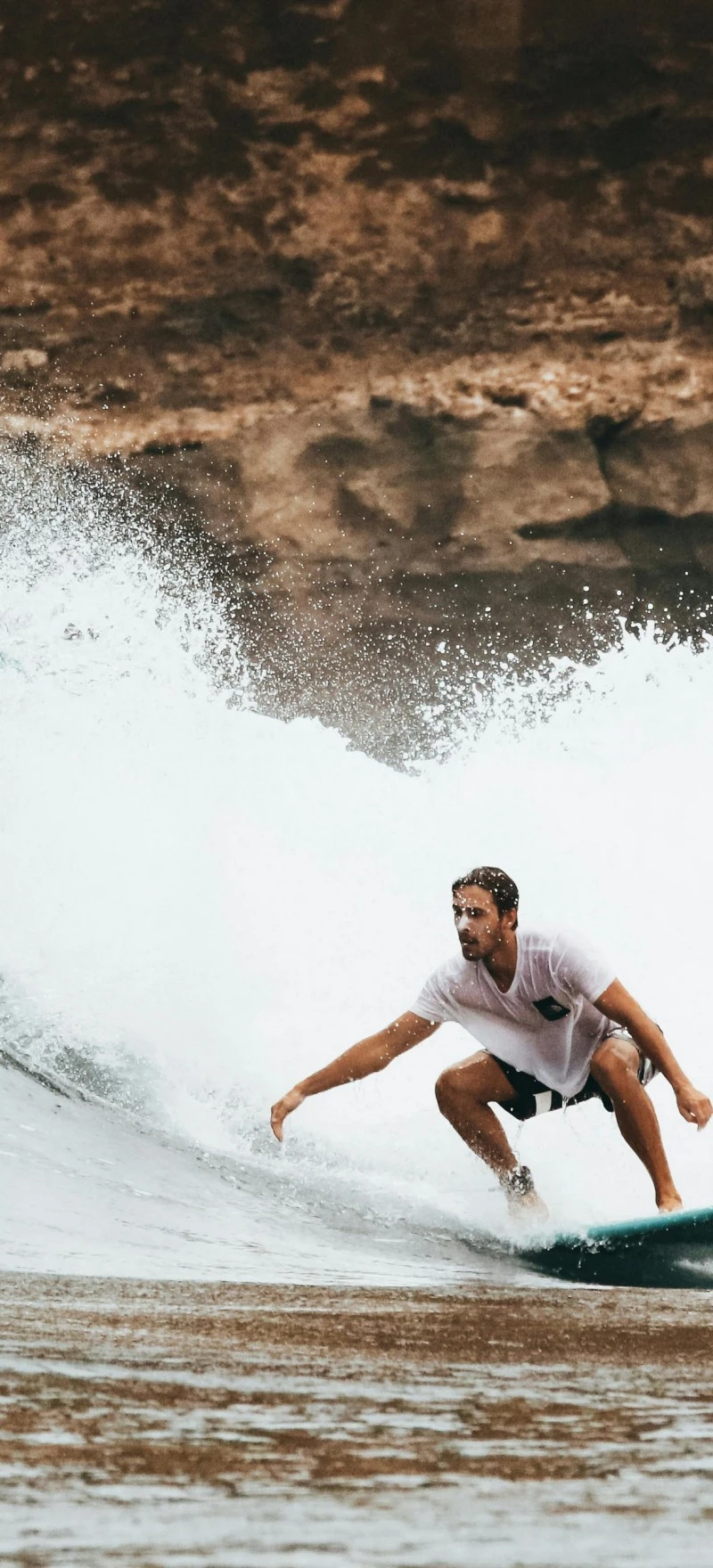 Surfer Riding a Wave 4K Mobile Wallpaper