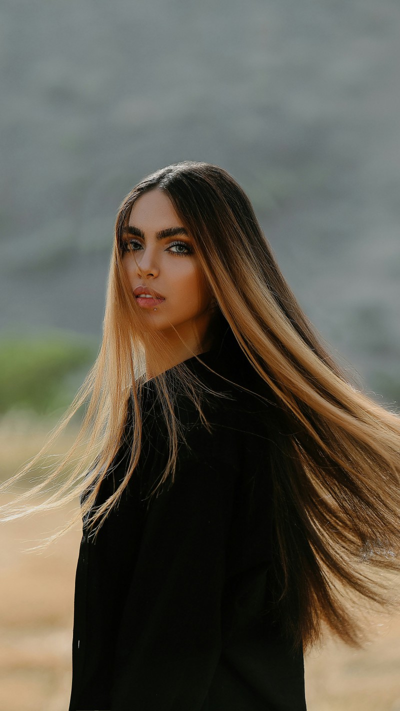 Wind Sweeps Through Girl's Hair 4K Mobile Wallpaper