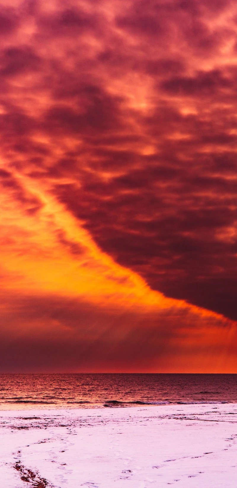 Fiery Sunset over Snowy Beach 4K Mobile Wallpaper