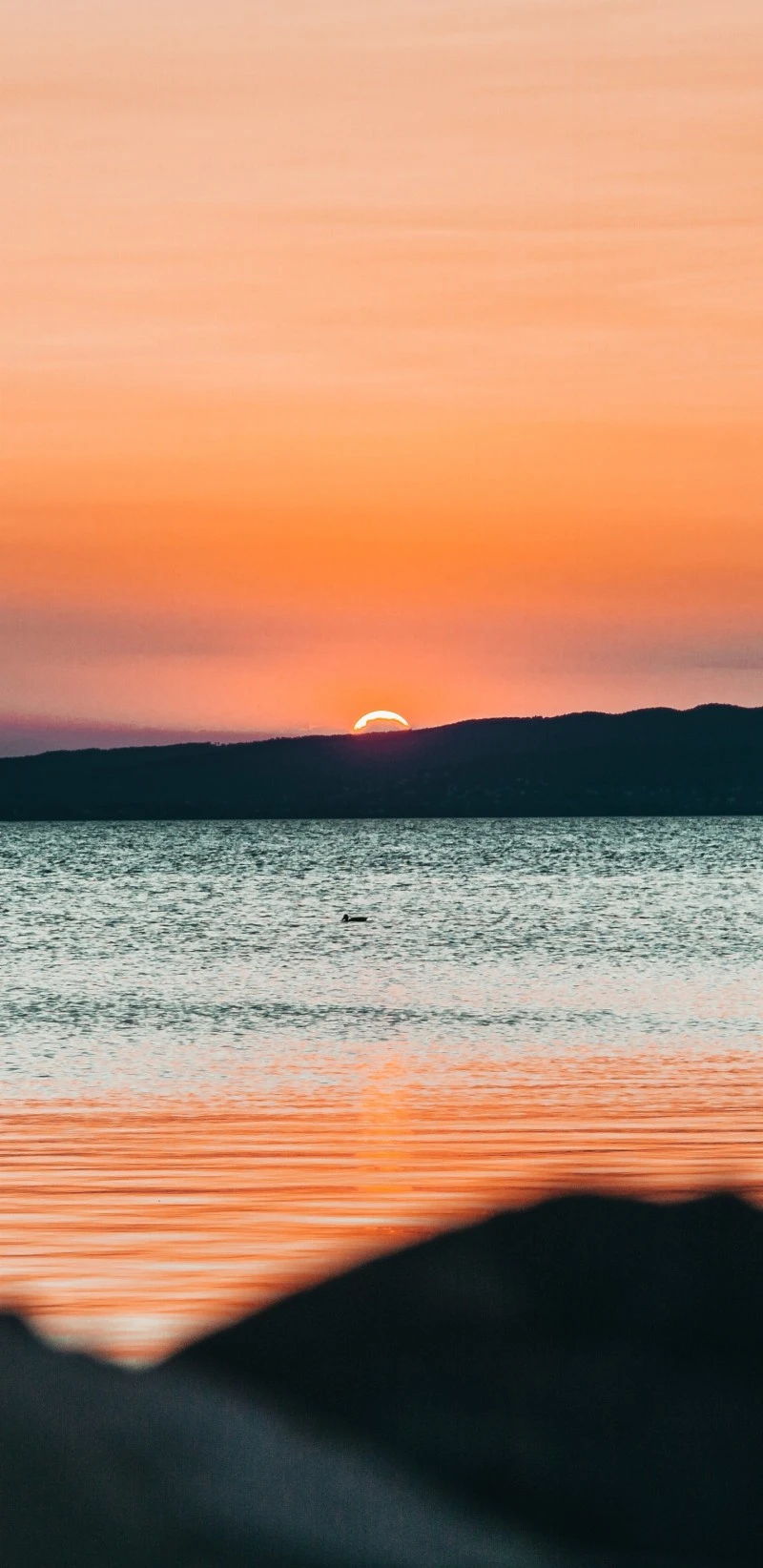 Serene Sunset over Calm Waters 4K Mobile Wallpaper