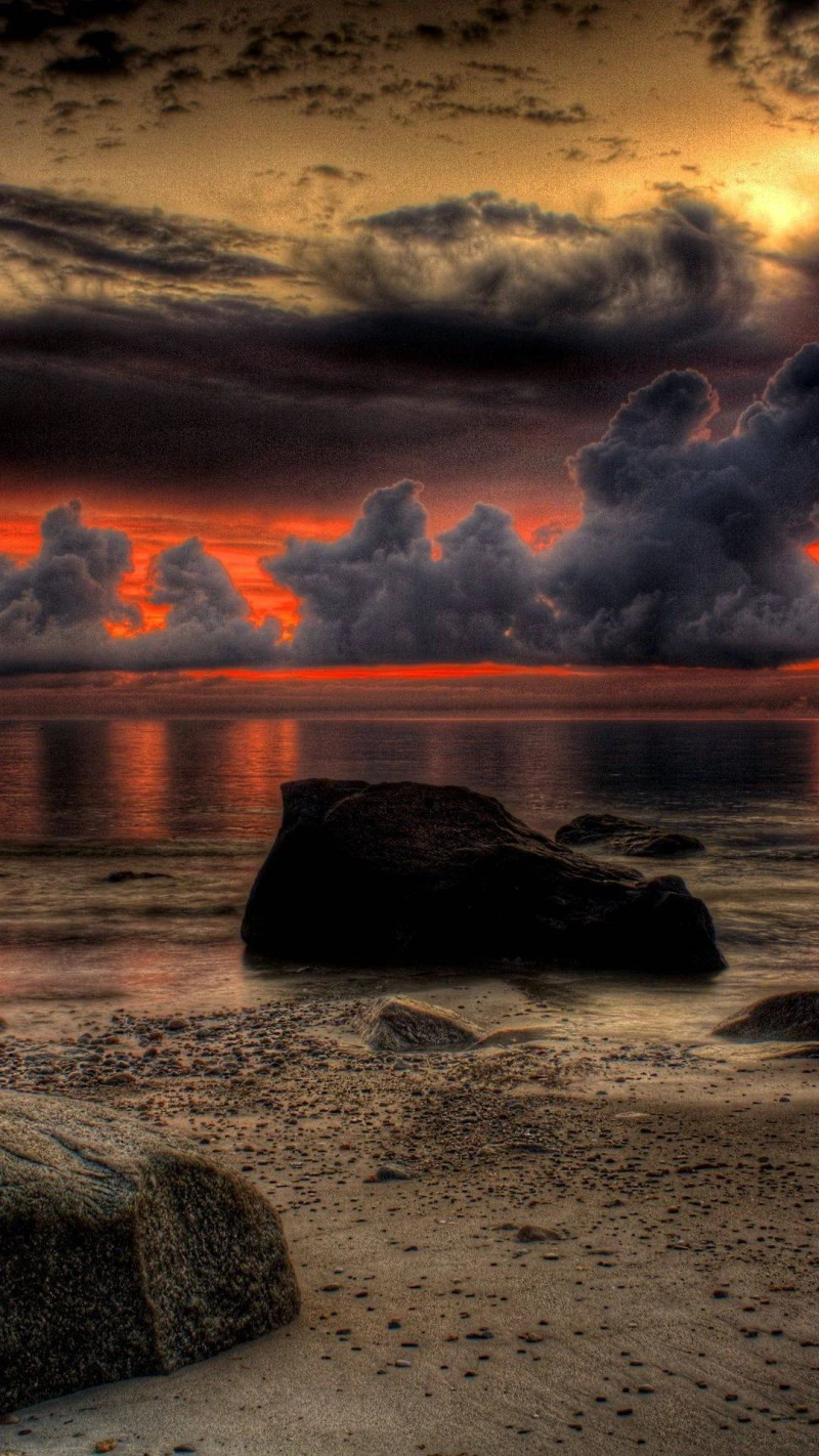 Fiery Sunset over Rocky Beach 4K Mobile Wallpaper