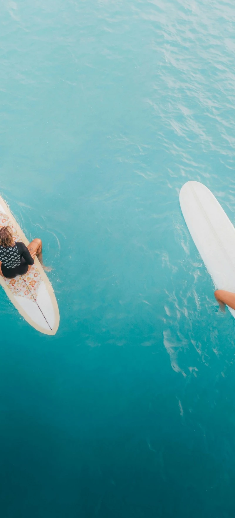 Two Surfers on Surfboards in Turquoise Water 4K Mobile Wallpaper