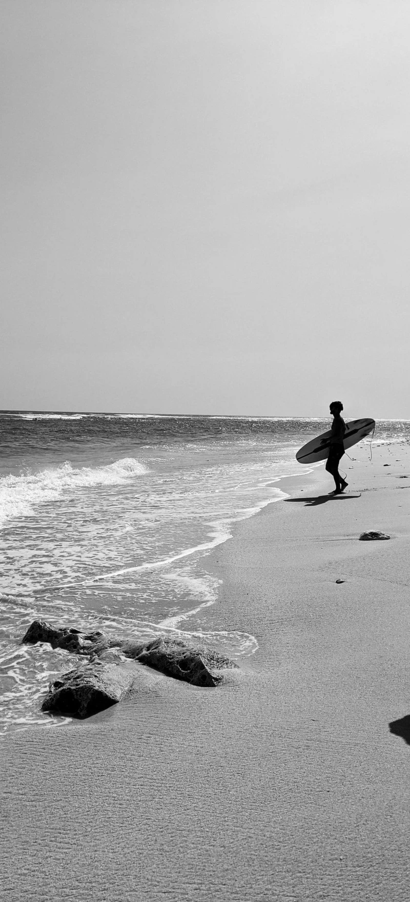 Surfer Silhouette on a Sandy Beach 4K Mobile Wallpaper