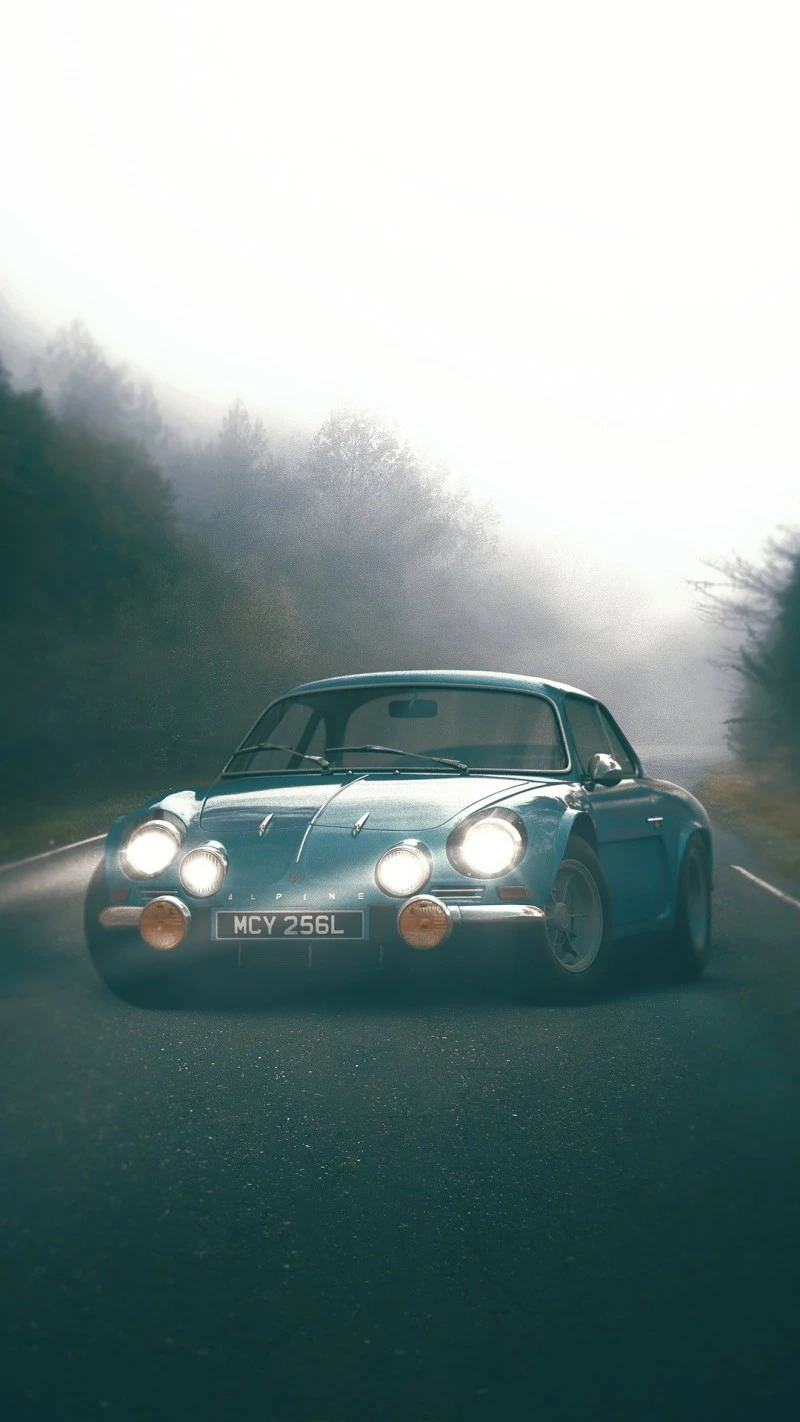 Alpine A110 in Misty Forest Road 4K Mobile Wallpaper