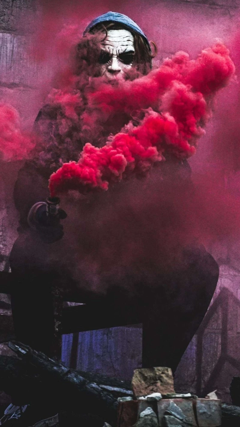Joker in Red Smoke 4K Mobile Wallpaper Free Download