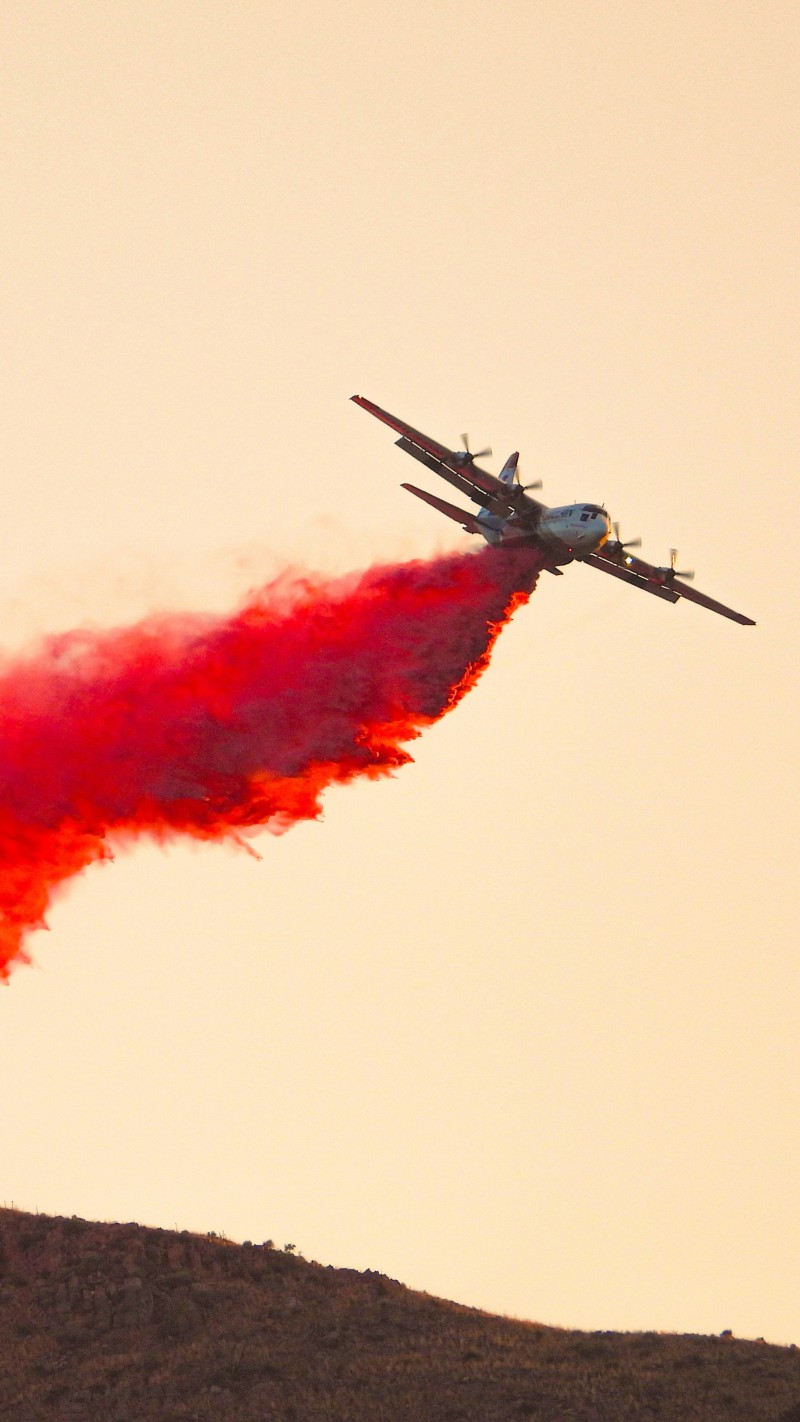 Airplane Drops Red Smoke 4K Mobile Wallpaper