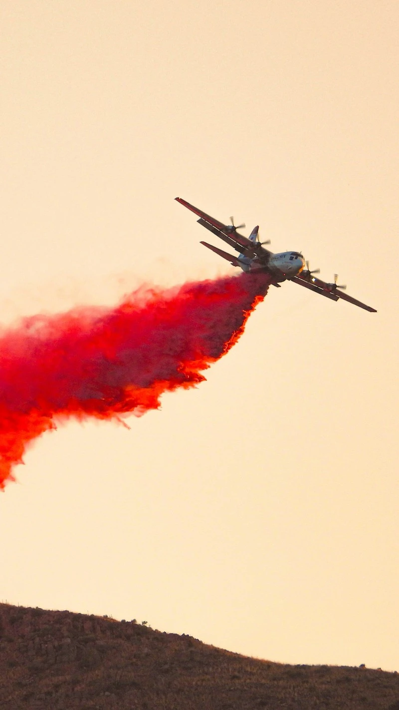 Airplane Drops Red Smoke 4K Mobile Wallpaper