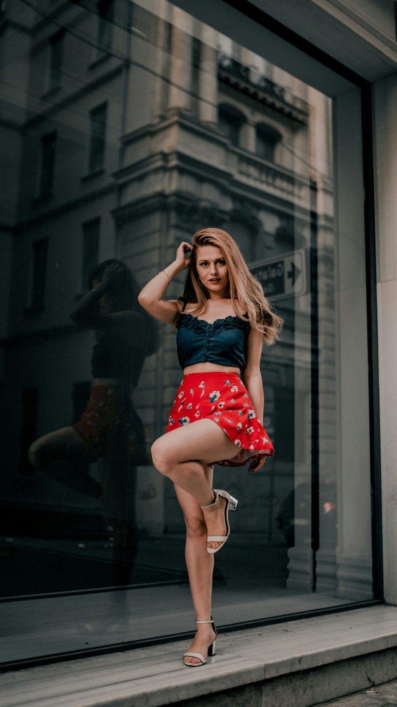Girl in Red Skirt Poses Playfully 4K Mobile Wallpaper