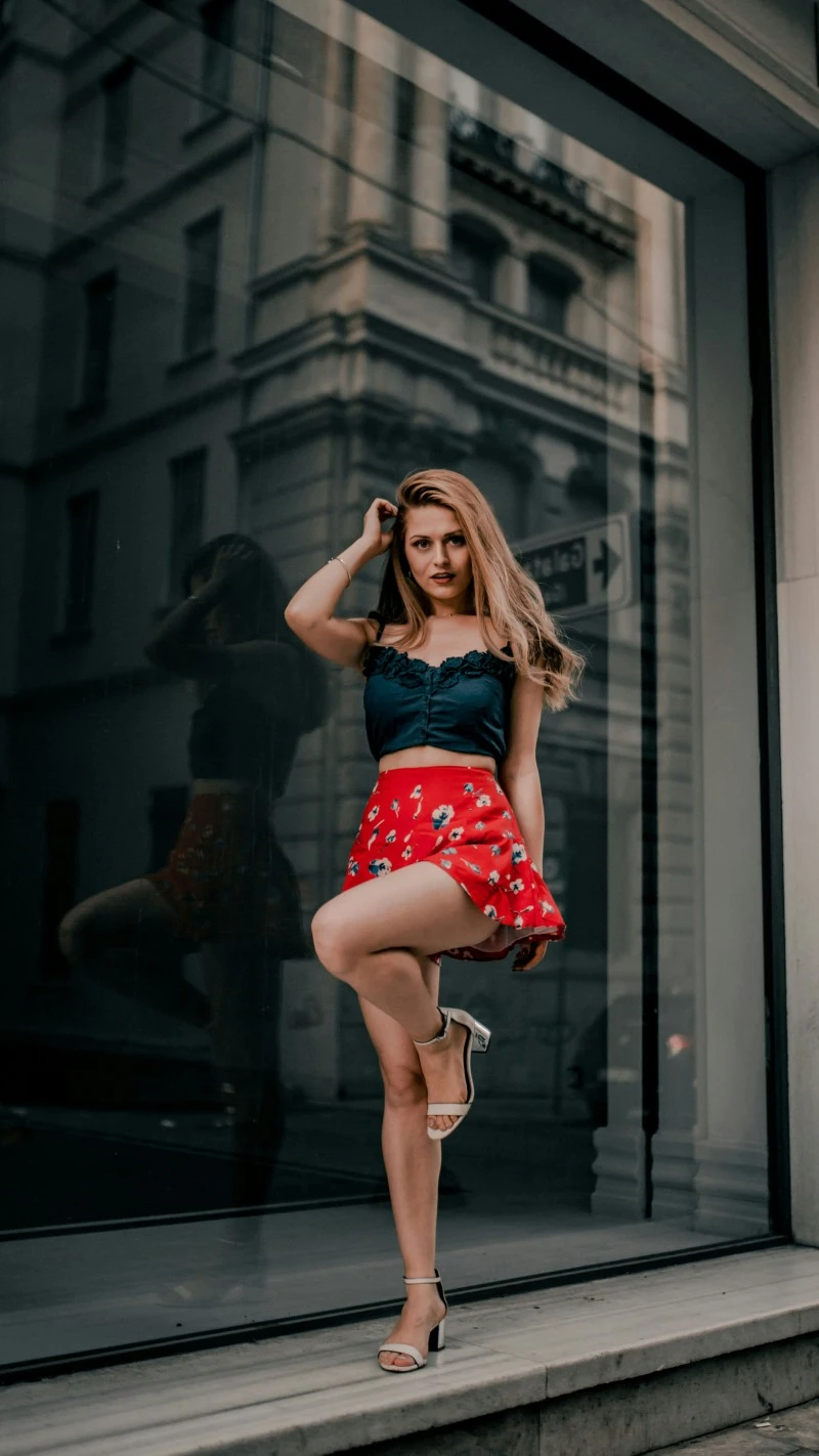 Girl in Red Skirt Poses Playfully 4K Mobile Wallpaper