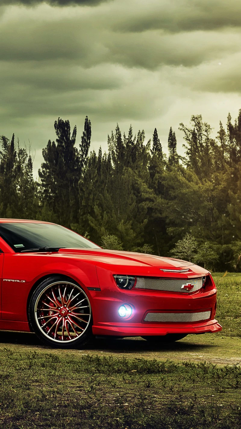 Red Chevrolet Camaro in a Forest Setting 4K Mobile Wallpaper